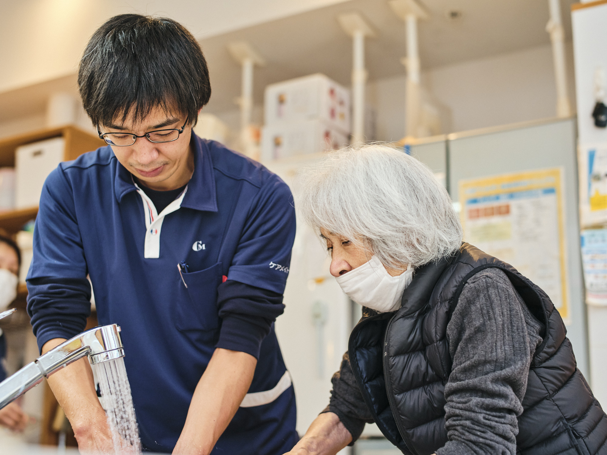 ご利用者様と一人と手を洗う篠原さんの写真